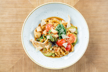 Italian pasta tagliatelle with seafood and tomato sauce. Pasta Gamberini. Parmesan cheese