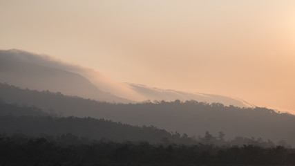 Silhouette of Mountain With Fluffy Clouds during Sunrise