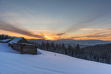 Winter landscapes of Ukrainian Carpathians with fog and snow mountain peaks