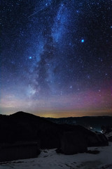 Wonderful night views of the Carpathian winter mountains with millions of stars in the sky and beautiful scenery