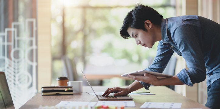 UX web developer working on his project about UX template while using laptop computer