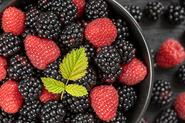 Background from fresh organic blackberries and raspberries, close up. Top view blackberry and raspberry