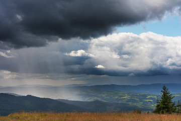 Fototapeta premium Mountain scenery with fog, rain, dramatic sky and beautiful scenery.