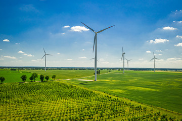 Big wind turbine on field in sunny Poland, aerial view © shaiith