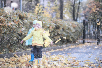 Kids walk in the park first snow