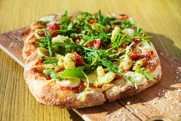fresh pizza with calamari and arugula