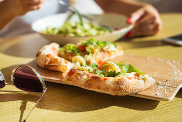 woman eating pizza in the cafe