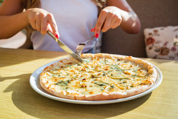 woman eating pizza in the cafe