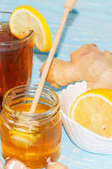 Cup of natural tea with ginger, lemon and honey on a light background. Healthy drink. The concept of a hot winter drink.