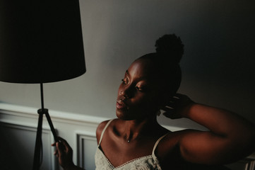 portrait african young woman in nightie in bedroom