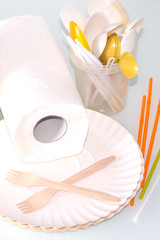 Disposable picnic dishes on a light background. Sale of disposable tableware.