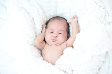 The baby sleeps in the bed