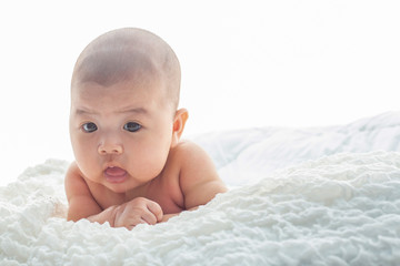 Baby lying on the bed