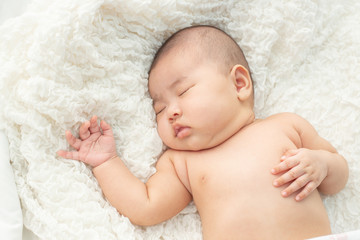 Baby lying on the bed