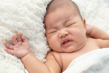 Baby lying on the bed