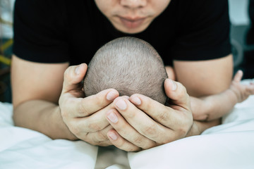 Baby sleeps in father's hand,selective focus