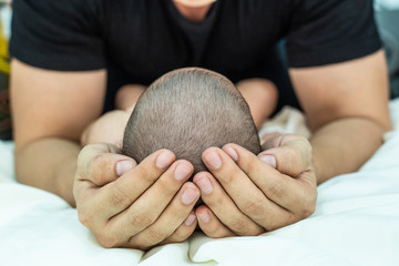 Baby sleeps in father's hand,selective focus