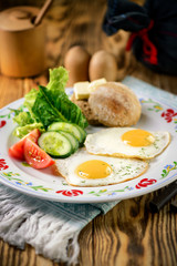 traditional breakfast dish, fried eggs with vegetables