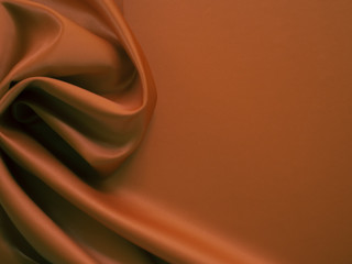 Beautiful smooth elegant wavy brown satin silk luxury cloth fabric texture, abstract background design. Copy space.