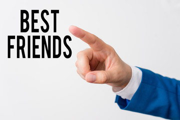 Writing note showing Best Friends. Business concept for A demonstrating you value above other demonstratings Forever buddies Isolated hand pointing with finger. Business concept pointing finger