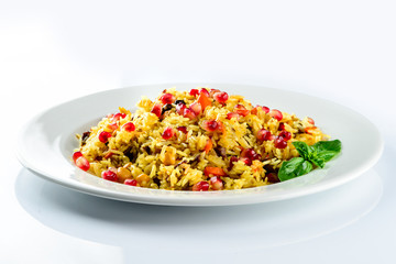 Uzbek pilaf with pomegranate on a white plate