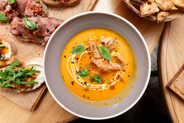 Plate of pumpkin pureed soup shot from above