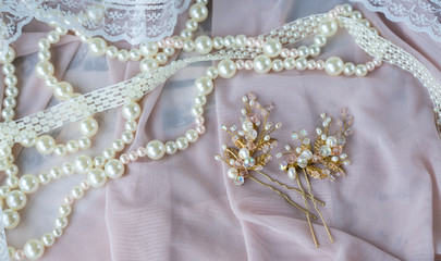Wedding background with pearls and hair accessories on pink background