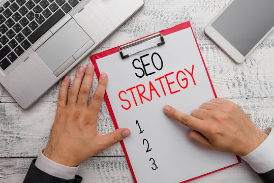 Writing note showing Seo Strategy. Business concept for Techniques and tactics to increase the visitors of a website