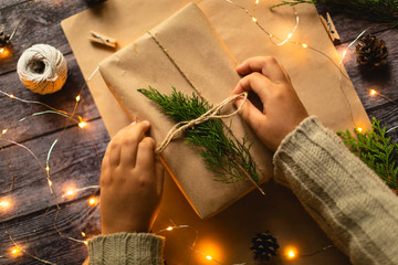 Hands Gift wrapping in eco style, christmas