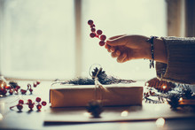 hands wrapping gift in craft paper, christmas mood