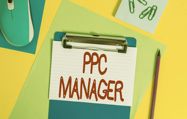 Word writing text Ppc Manager. Business photo showcasing which advertisers pay fee each time one of their ads is clicked Clipboard striped sheets marker clips notepad mouse colored background