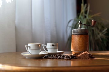 Obraz na płótnie Canvas Coffee is pouring from a moka pot to two cups