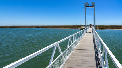 Pedestrian bridge connecting Pedra del Rei with Ilha de Tavira and Barril beach, Algarve, Portugal