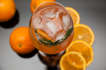 summer cocktail with ice and oranges on a black background