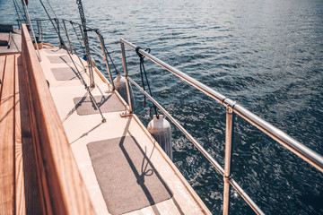 Board of a motor or sailing yacht at sea at sunset. The concept of sea or river cruises. Tranquil and freedom.