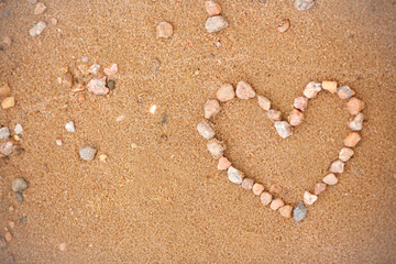 Fototapeta na wymiar Heart. Concept with heart with copy space. Heart on the beach. Heart made of stones on the beach. Photo background on the theme of vacation, sea, vacation, love, valentines day and wedding
