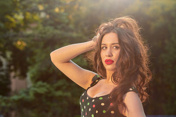 Fototapeta premium Elegant young woman posing in the park.