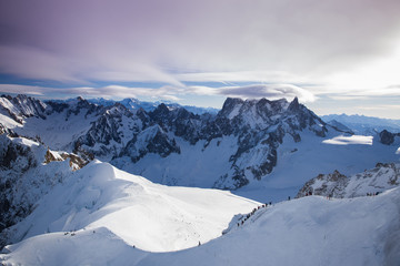 View from Aiguille du Midi, France. Skiers going down on Mer de Glace .