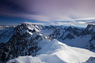 View from Aiguille du Midi, France. Skiers going down on Mer de Glace .