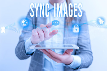 Handwriting text Sync Images. Conceptual photo Making photos identical in all devices Accessible anywhere Female human wear formal work suit presenting presentation use smart device