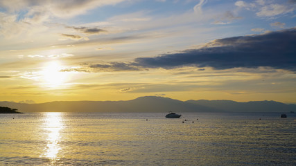 Solar halo, sunset on the Adriatic coast. In the background - the coast of Istria, Mount Vojak