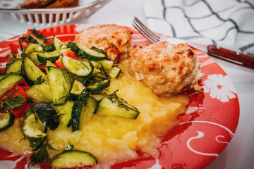 Meat cutlet with mashed potatoes and cucumbers