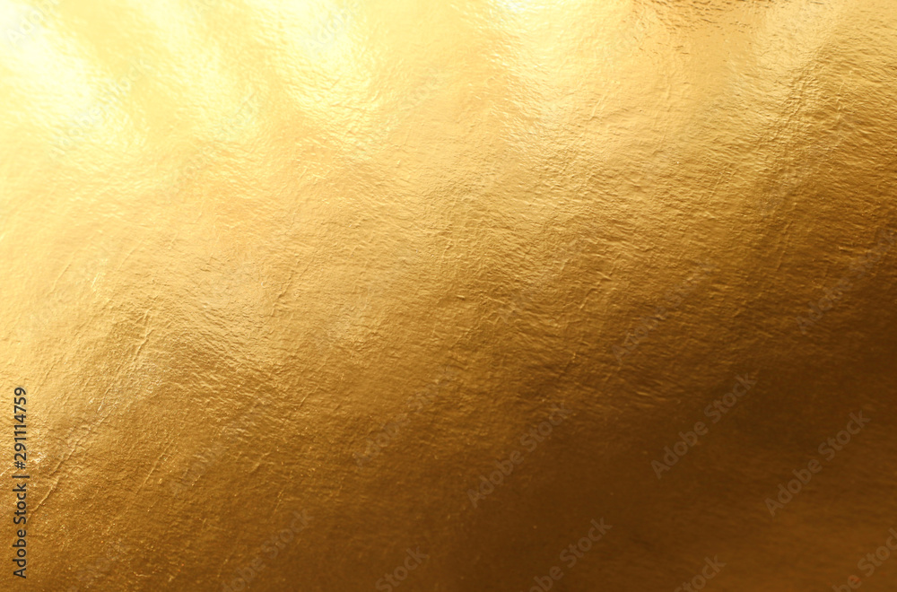 Wall mural background of gold foil texture with light reflections