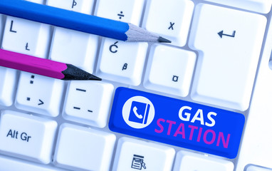 Writing note showing Gas Station. Business concept for for servicing motor vehicles especially with gasoline and oil White pc keyboard with note paper above the white background