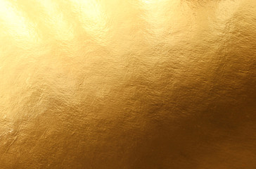 background of gold foil texture with light reflections