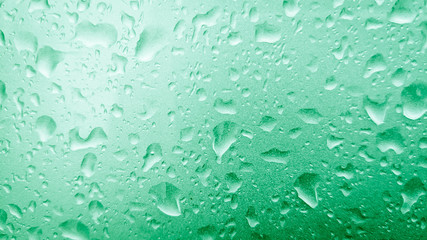 Mint colored holiday glitter background. Blurred festive green backdrop for your design. Holiday concept, new year celebration. Midnight green colored. Water drop