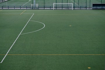 empty soccer field, green grass int he stadium