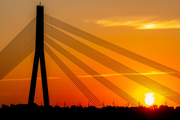 Fototapeta na wymiar Big cable bridge and beautiful sunset 
