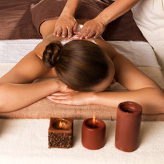 Obraz na płótnie Canvas Masseur doing massage on woman body in the spa salon.