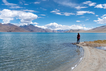 Landscape view of tourist woman enjoy with beautiful of Pangong lake in Leh Ladakh, India